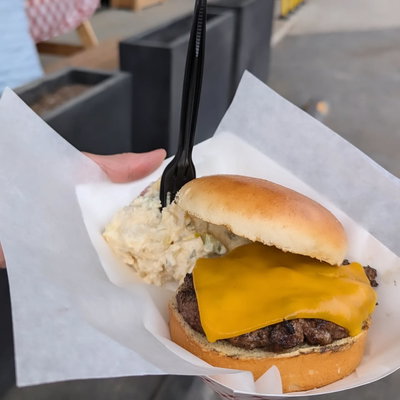 A West Side cheeseburger with cheddar and a side of potato salad
