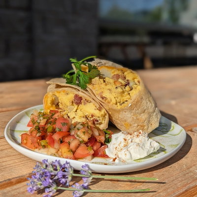 A West Side breakfast burrito cut open with fresh pico de gallo