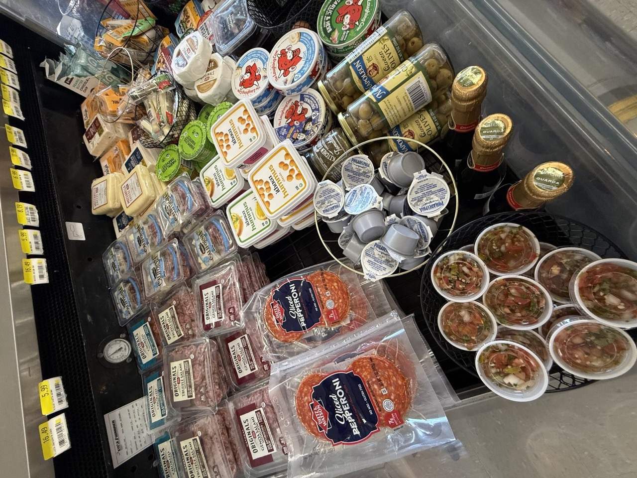 The deli case with salami, olives, and soft cheese at Westside Market