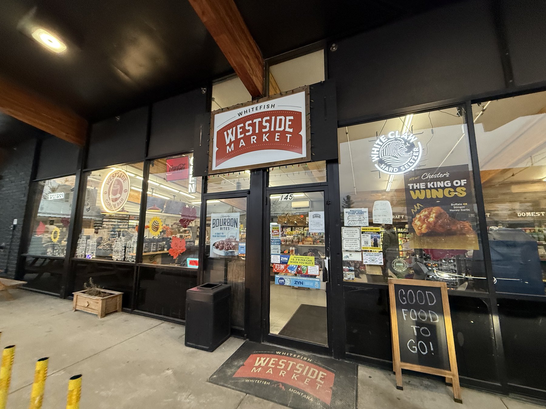 The West Side Market storefront on 2nd Street in Whitefish at dusk